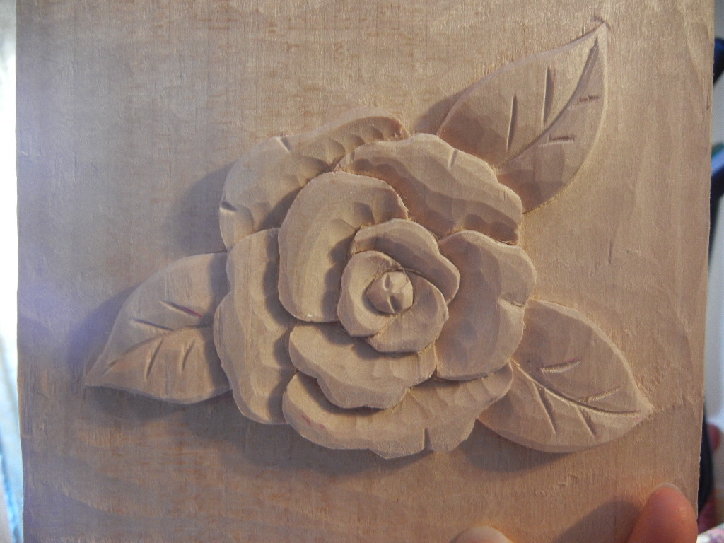 carving a camelia flower in wood
